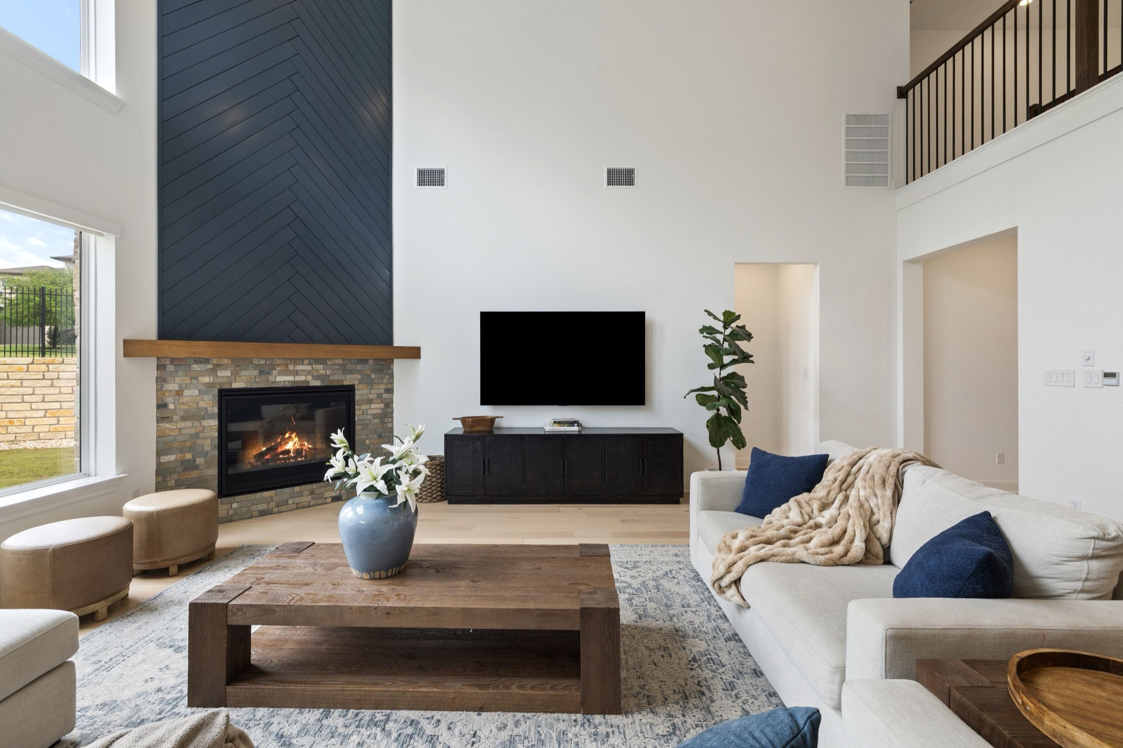 Living room with tall windows and fireplace